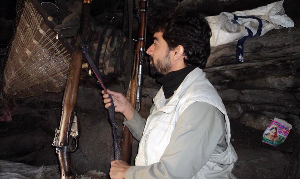 In an isolated Nuristan village, in Hindu Kush Mountains. Shown are two rifles for the protection of a summer residence for the locals