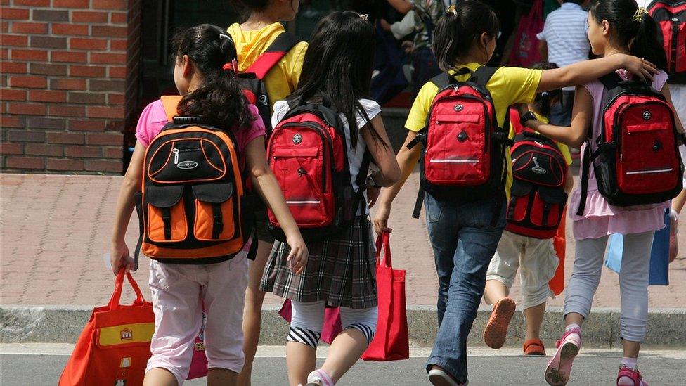 Children whose parents defected from North Korea, arrive from a school to the South Korean Hanawon resettlement facility on July 8, 2009 in Ansung, South Korea