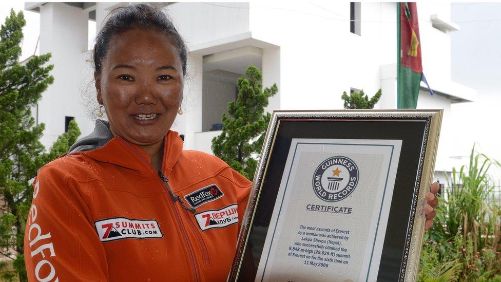 Nepalese climber Lhakpa Sherpa, who holds the world record for most successful climbs of Mount Everest for a woman with seven ascents, poses with her Guinness record certificate in Kathmandu on May 27, 2016.