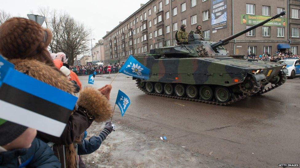 Spectators watch a tank during a parade as part of an event to celebrate 97 years since first achieving independence in 1918 in February 2015 in Narva, Estonia.