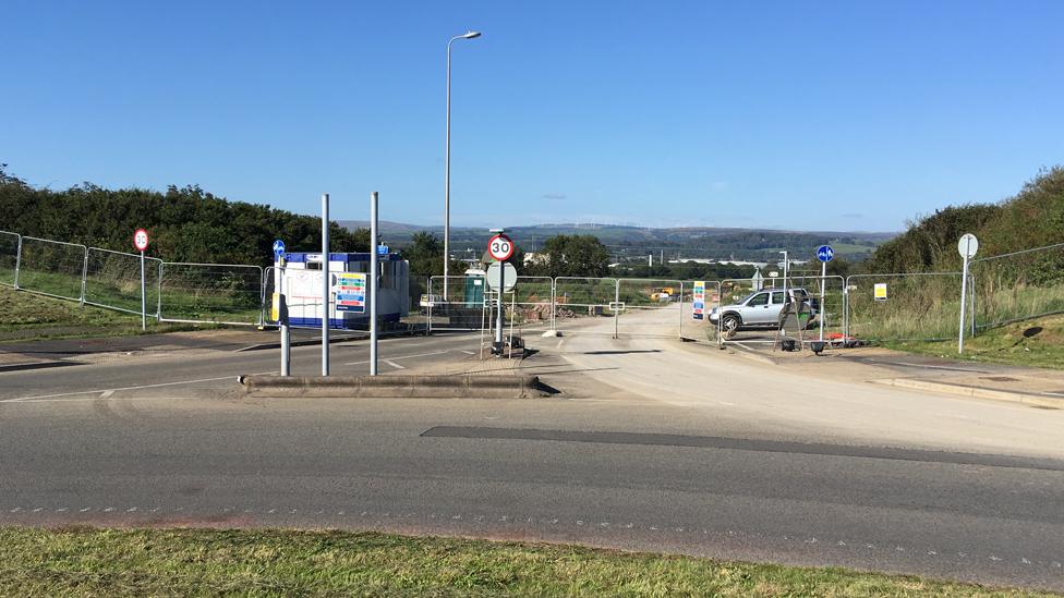 The fenced-off entrance to the new site