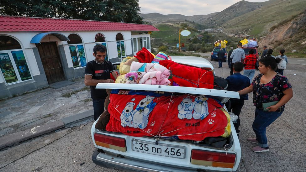 Ethnic Armenians from Nagorno-Karabakh stop for a rest during their way to Goris, Armenia, on 27 September 2023.