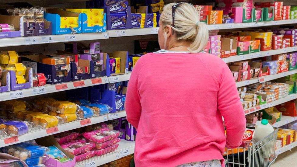 Woman browsing food shelves