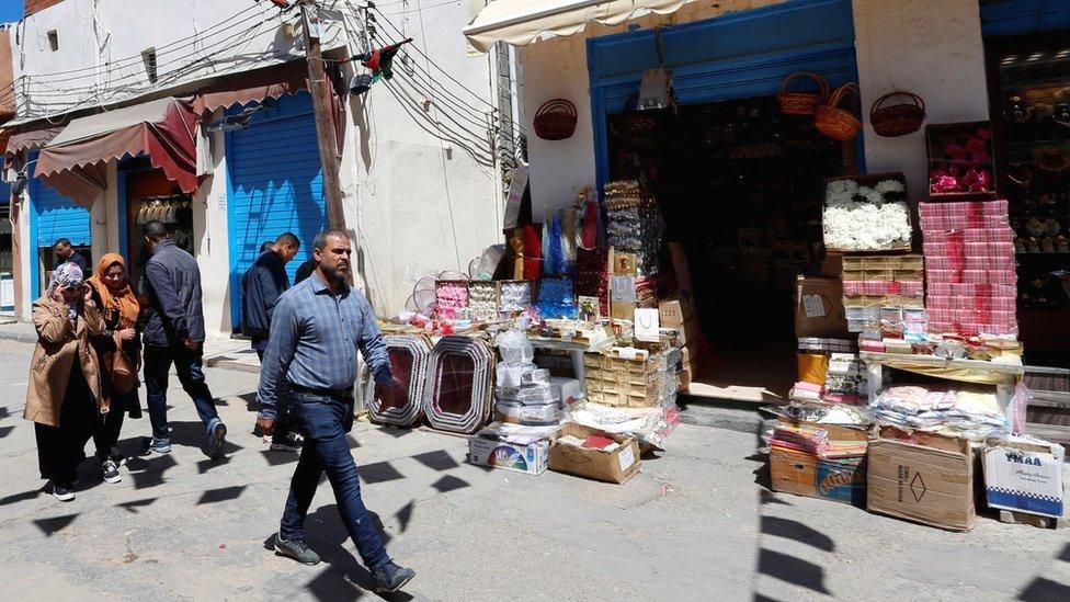 People walk at a market in the old city of Tripoli, Libya - 6 April 2019