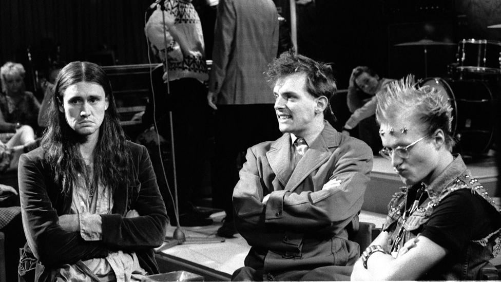 Nigel Planer, Rik Mayall and Adrian Edmondson (r) on set during the filming of The Young Ones in 1982