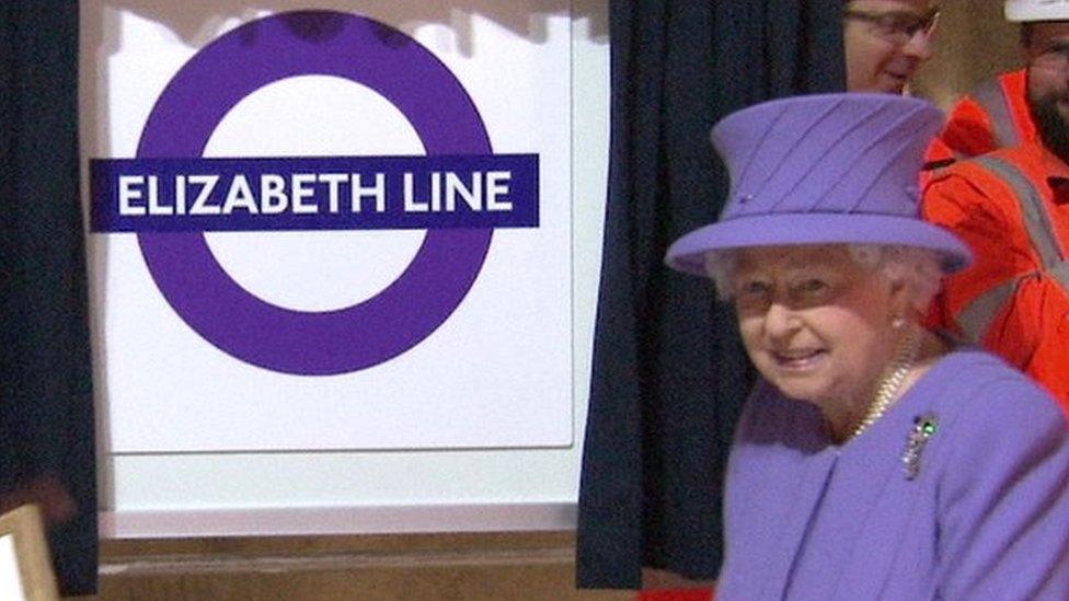 The Queen beside new logo for the line