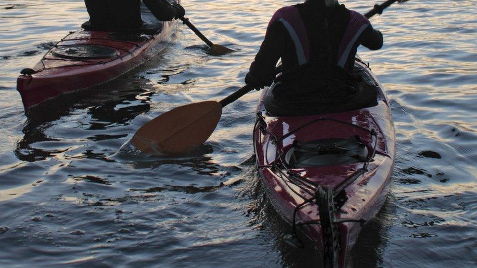 Kayakers on waves