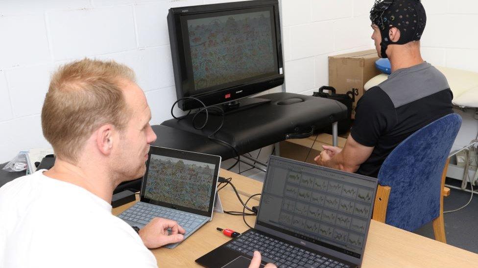 Dr Ben Jones checks baseline levels for a Colchester RUFC player using a Where’s Wally game