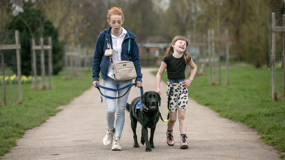 Family walking dog