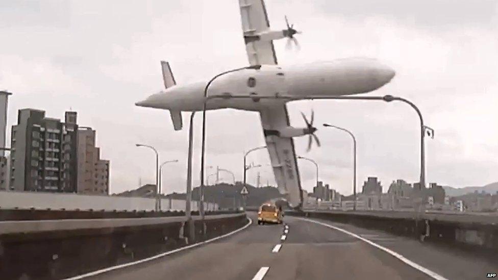 File photo: This screen grab taken from video provided courtesy of TVBS Taiwan on 4 February 2015 shows a TransAsia ATR 72-600 turboprop plane clipping an elevated motorway and hitting a taxi (centre) before crashing into the Keelung river outside Taiwan's capital Taipei in New Taipei City