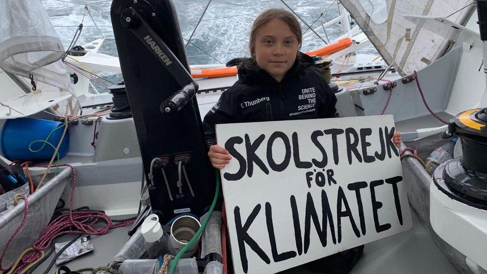 greta-thunberg-on-boat-holding-sign