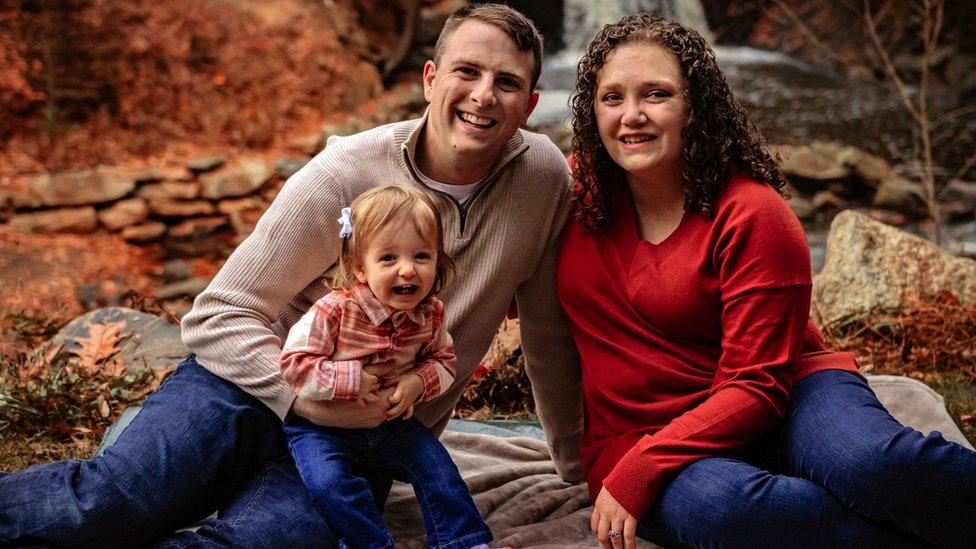 Julie Eshelman with her husband and baby