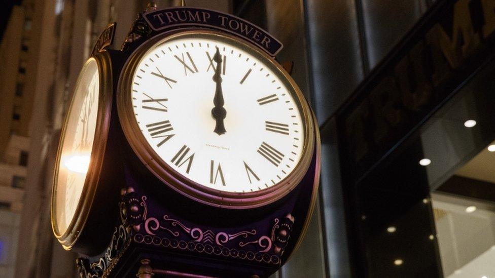 A clock sits outside of Trump Tower