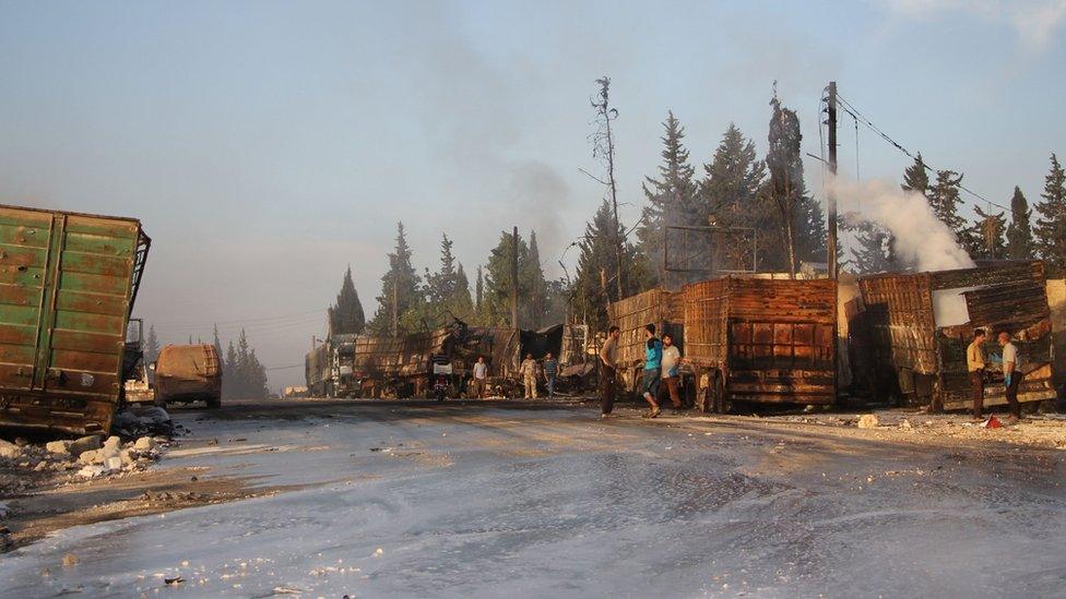 Syrians gather near damaged trucks which was part of a convoy carrying aid (20 September 2016)