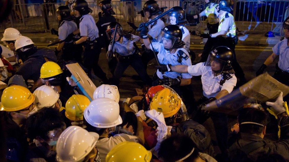 Police clash with pro-democracy protesters on an occupied road in the Admiralty district of Hong Kong on November 30, 2014