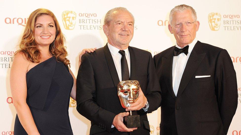 Karren Brady, Lord Alan Sugar and Nick Hewer pose in front of the winners boards at the Arqiva British Academy Television Awards 2012