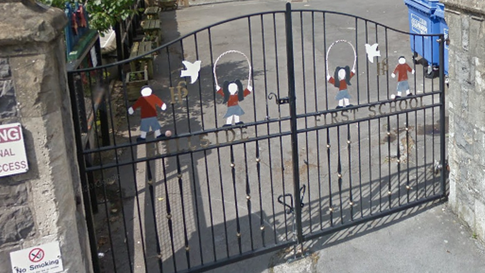 Hillside First School entrance with figurines of children on the gates