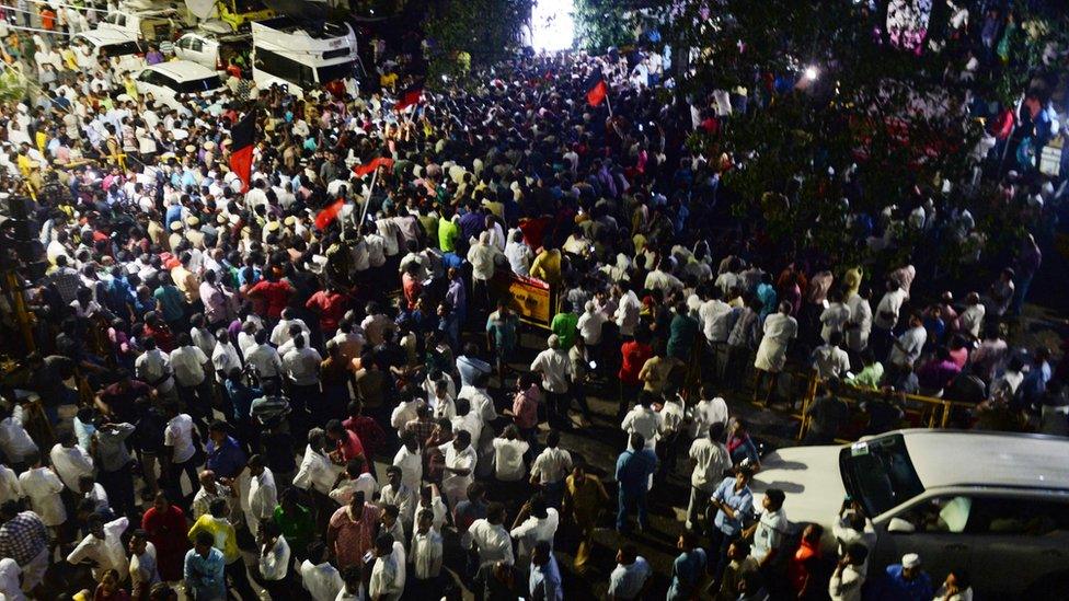 Dravida Munnetra Kazhagam (DMK) party supporters gather in front of the hospital where DMK party president M. Karunanidhi is being treated