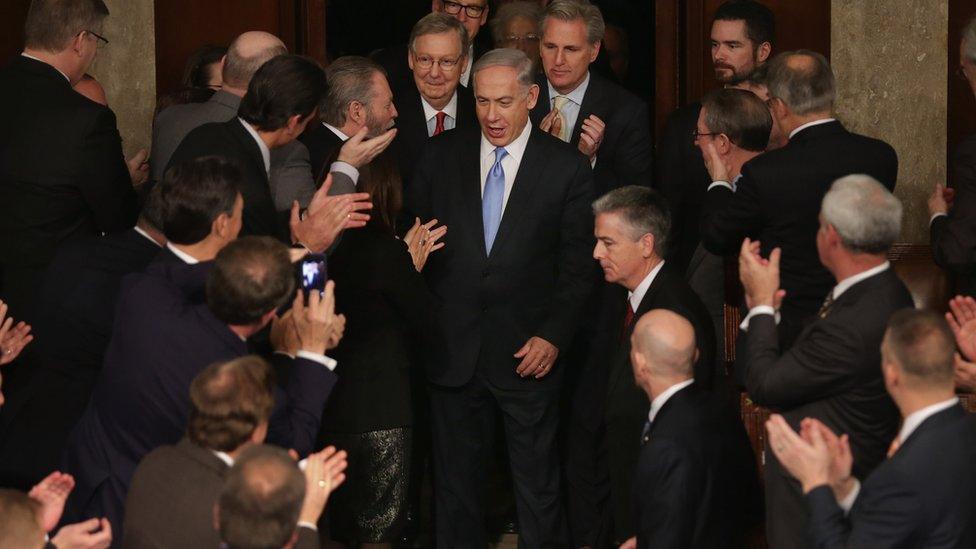 Israeli Prime Minister Benjamin Netanyahu (C) is greeted by members of Congress as he arrives to speak during a joint meeting of the United States Congress in the House chamber at the U.S. Capitol March 3, 2015 in Washington, DC