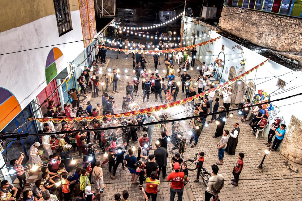 People enjoy a street celebration during Ramadan