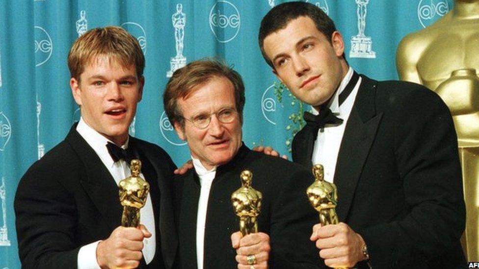 Williams with his Oscar, flanked by co-stars Matt Damon and Ben Affleck