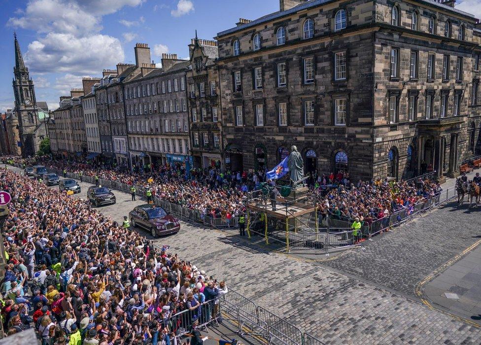 Crowds of people gather at St Giles