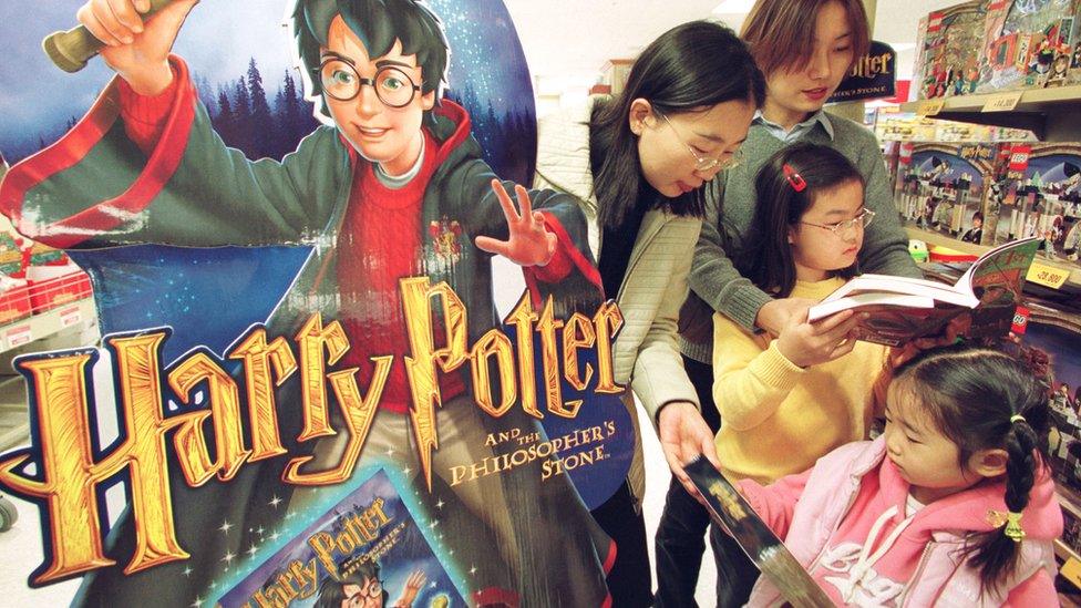 family in south korean bookstore reading harry potter books