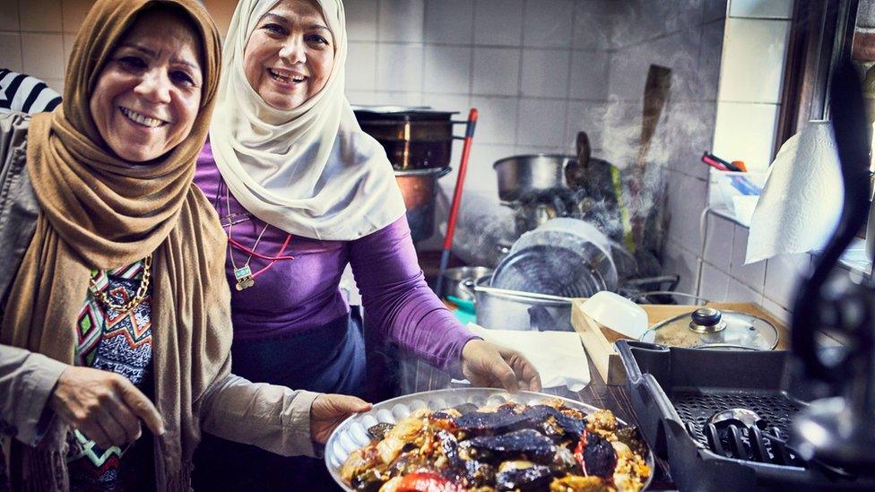 Intlak Al Saiegh and Ahlam Saeid cooking at the Hubb Community Kitchen