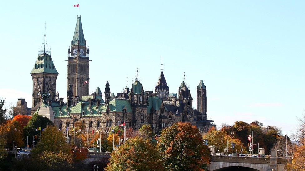 The Canadian flag flies over the Parliament hill in Ottawa, Canada