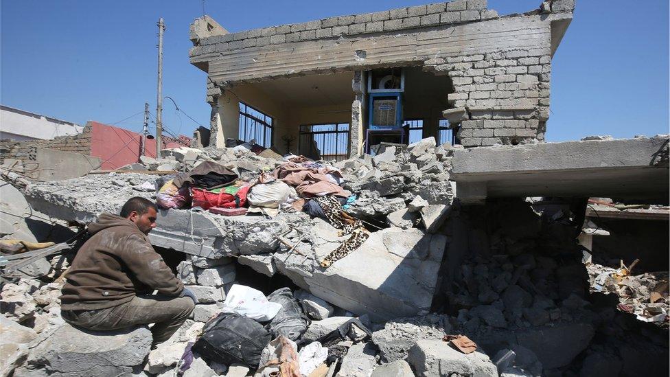 This file photo taken on March 26, 2017 shows An Iraqi man amid the rubble of destroyed houses in the Mosul al-Jadida area, following air strikes in which civilians have been reportedly killed during an ongoing offensive against the Islamic State (IS) group. U