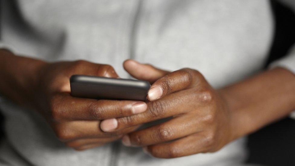 Teenager using mobile phone