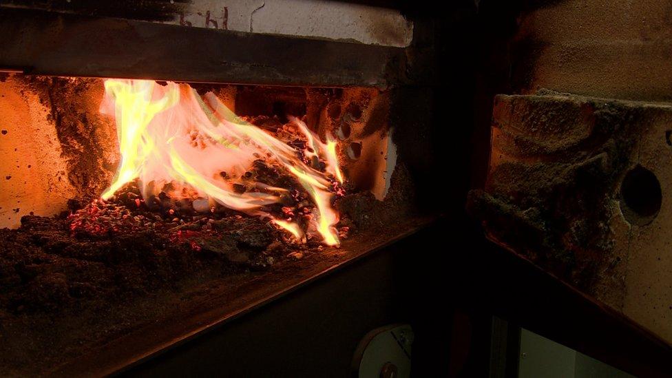 Burning wood pellets in a biomass boiler