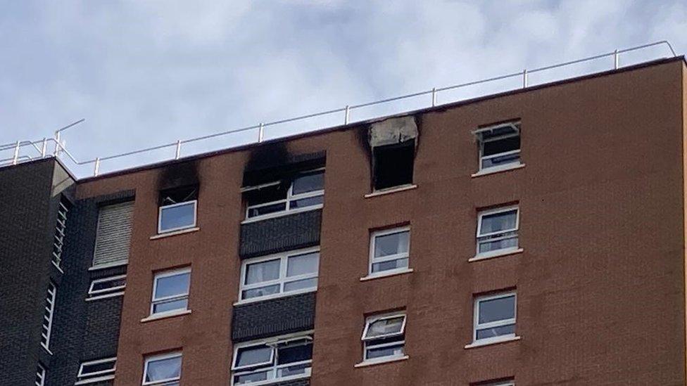 Housing block with scorched windows from a fire