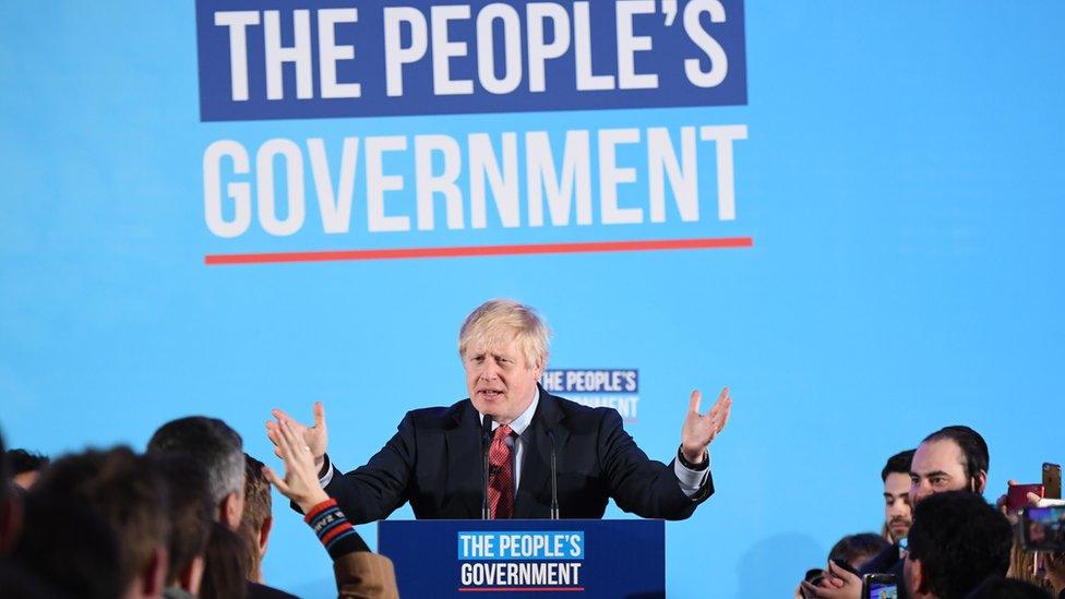 Boris Johnson at podium delivering speech at QE2 centre in central London