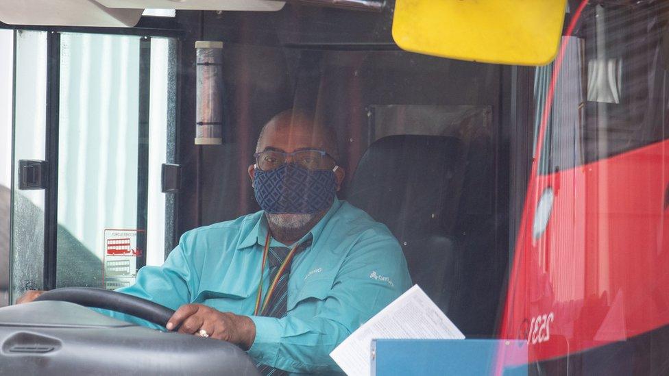 A London bus driver wearing a protective face mask