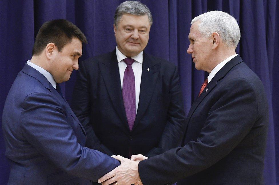 United States Vice President Mike Pence, right, shakes hands with Ukrainian Foreign Minister Pavlo Klimkin, left, as Ukraine's President Petro Poroshenko looks on, centre, during the Munich Security Conference in Munich, Germany, Saturday, Feb. 18, 2017.