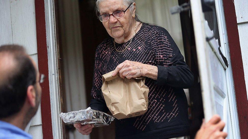 Tamara Lycholaj, 89, receives a hot meal from nutrition worker Al Patalona from the Sullivan County Office for the Aging as he makes 'Meals on Wheels' deliveries