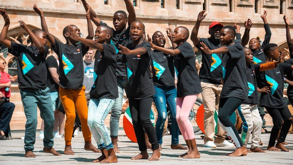 A choir of Zulu children singing and dancing