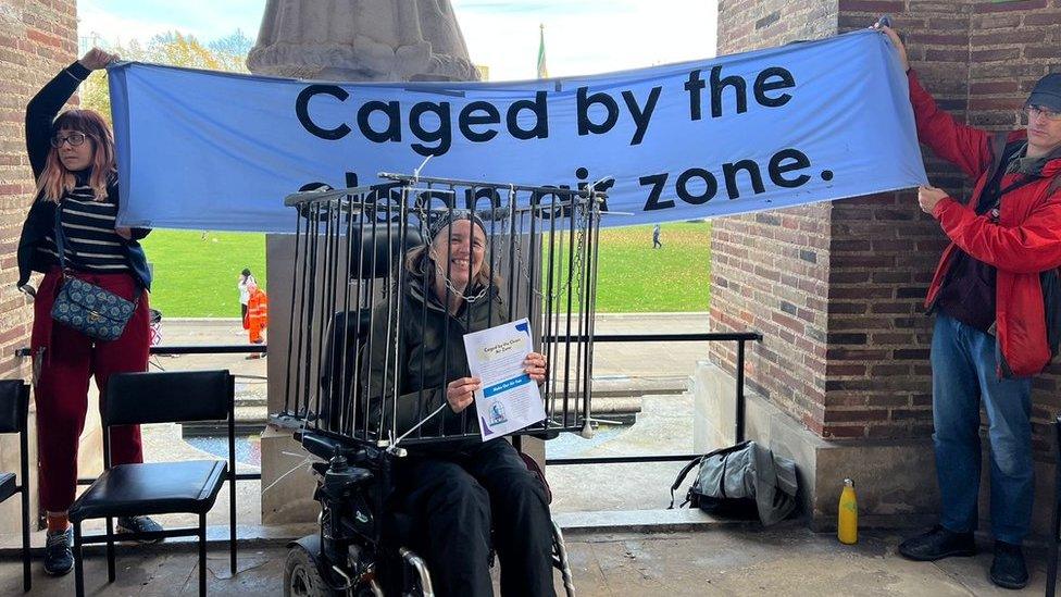 Bristol Disability Equality Forum protester in a cage