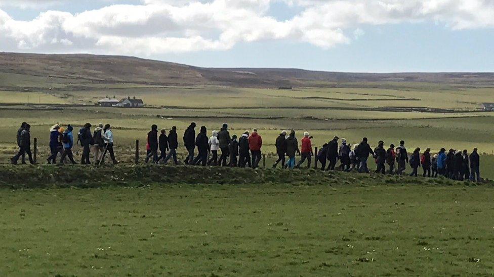 Walkers strung out across the landscape