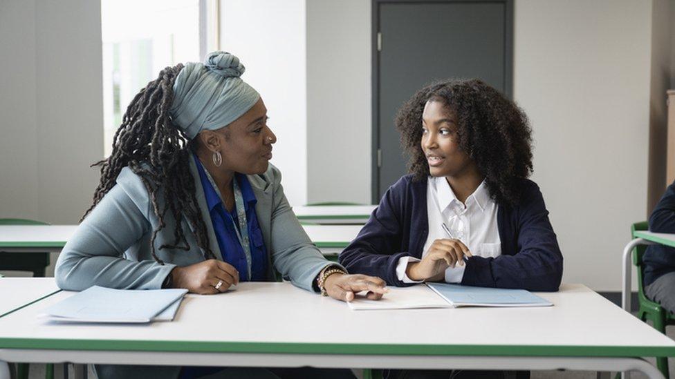 Stock image of teacher and pupil