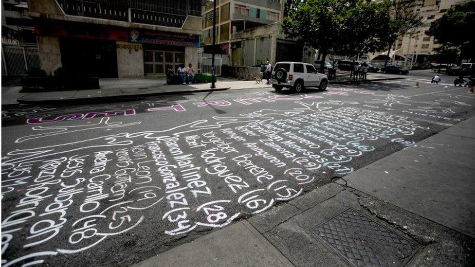 Outlines of the human body and victims" names of the two-month long protests are painted on a street in of Los Palos Grandes, east of Caracas, Venezuela, 04 June 2017.