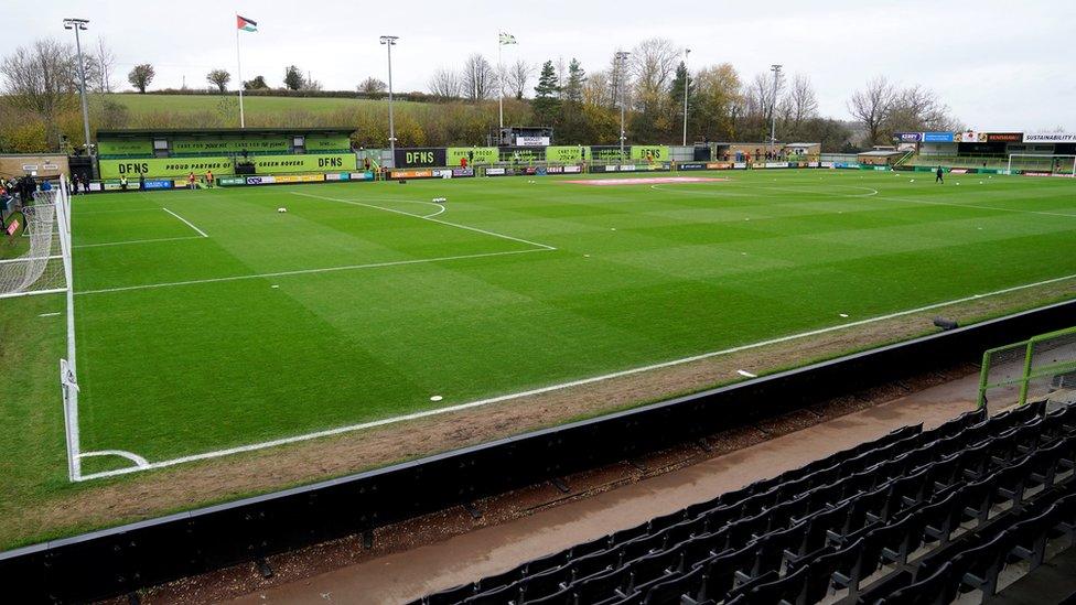 A general view of the stadium and pitch before a game. There are tall flags around the outside and the seats are empty