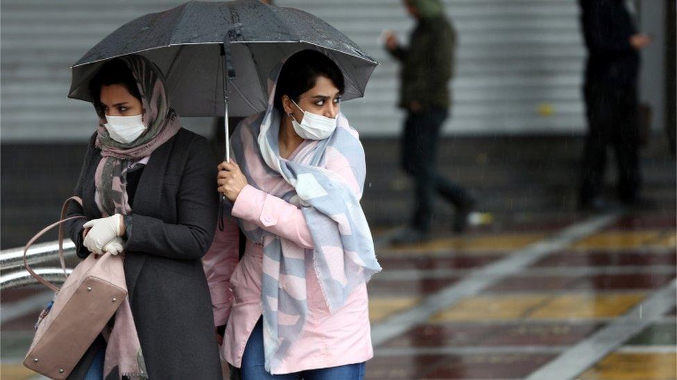 Iranian women in Tehran wear protective masks to prevent contracting coronavirus