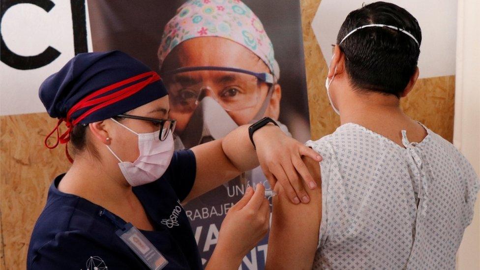 A volunteer in Mexico receives an injection