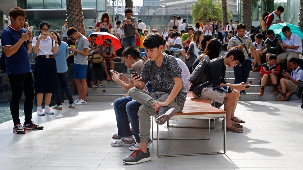 A large group of young Thai people using their phones to play Pokemon Go in Bangkok on 8 August 2016