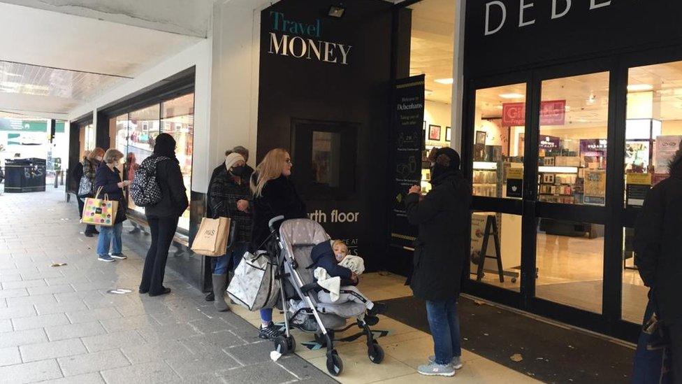 shoppers waiting to enter the Debenhams store in Norwich