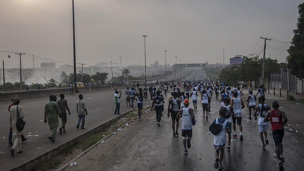 People take part in the Access Bank Lagos City Marathon at sunrise on February 6, 2016