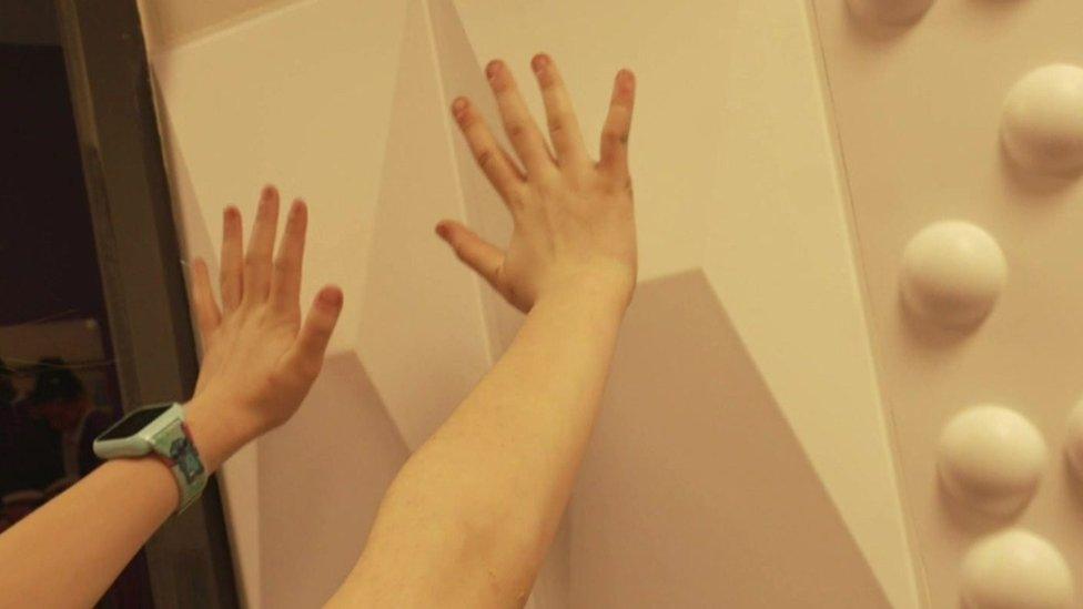 Lucy-Lu's hands against sensory wall