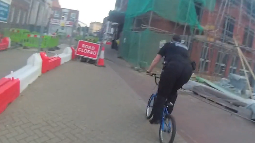 Video image of police officer on child's bike